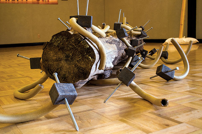 Greg Price’s sculpture, “Stuck between a log and a hard place,” took over 200 plus hours of physical labor to complete. Price has variety of personal symbolism in his work. His project is dedicated to the new part time faculty union. 

