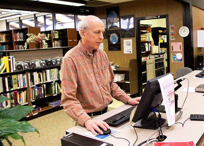 Hutchison sometimes helps out at the circulation desk.