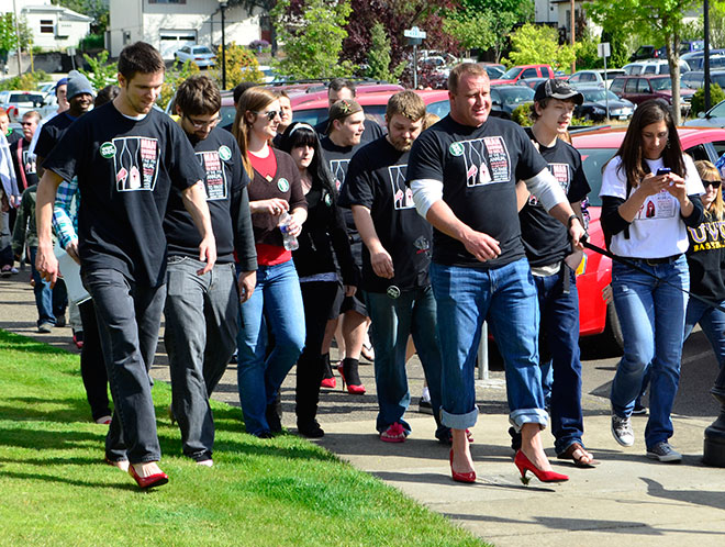 Students and staff marched in the Walk a Mile in her shoes fundraiser.